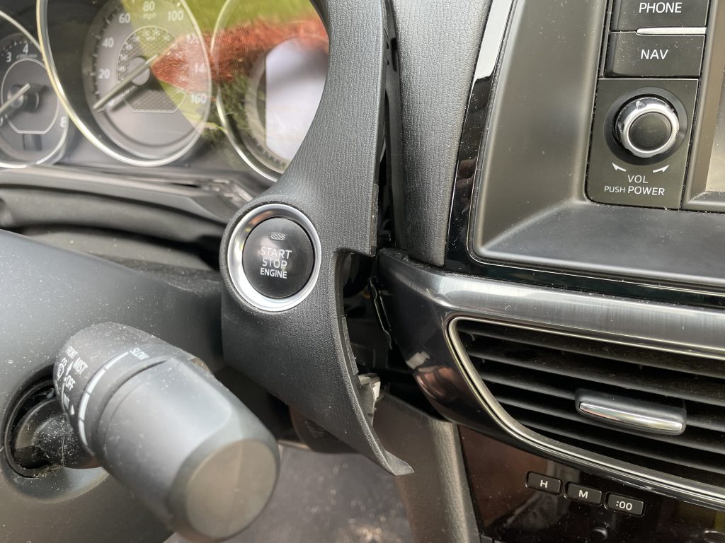 Detailed photo of the gauge cluster removal showing only the bottom right side being undone