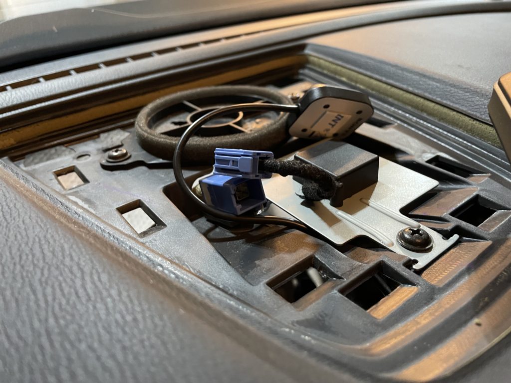 Shows location of stock Mazda GPS antenna in the center speaker grill. This speaker is a blank plate on non-Bose sound systems. The blank was removed to allow the Sony GPS antenna to mount flat.