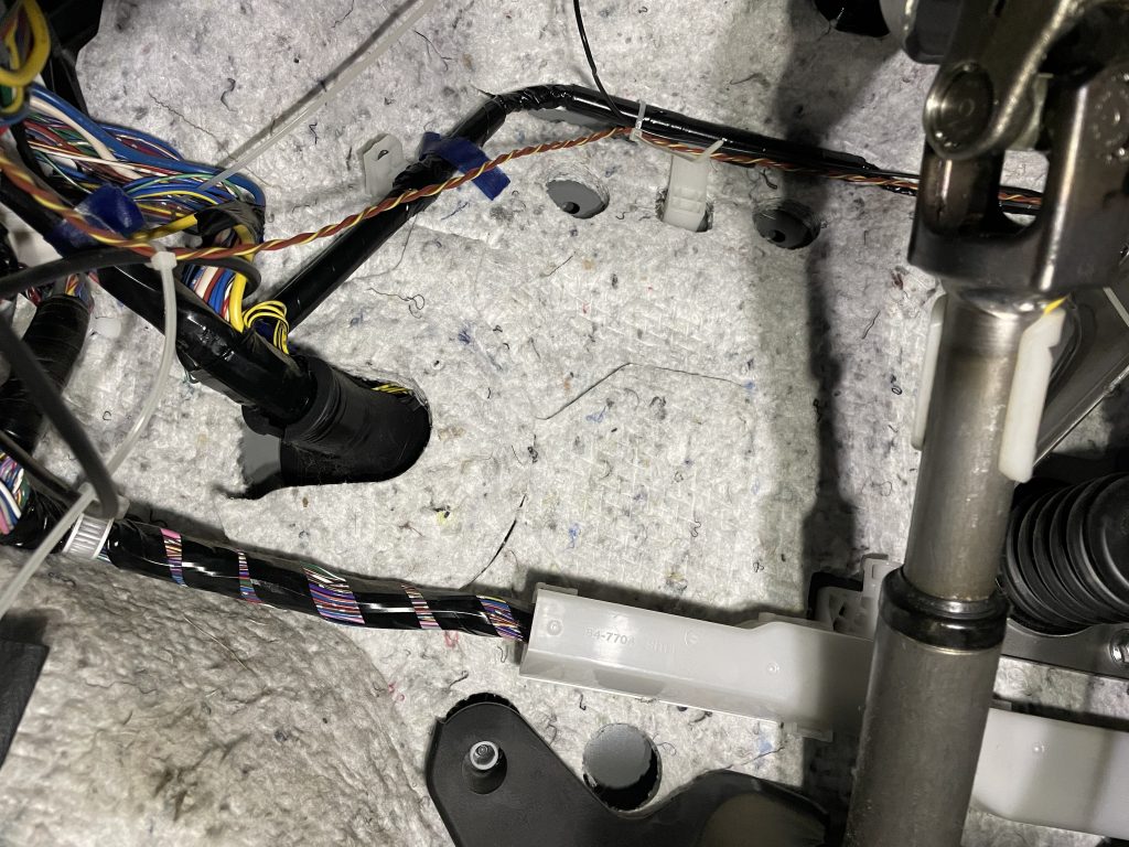 Shows how the OBDII and microphone cables are tied to existing wiring in the car to keep things clean and out of the way